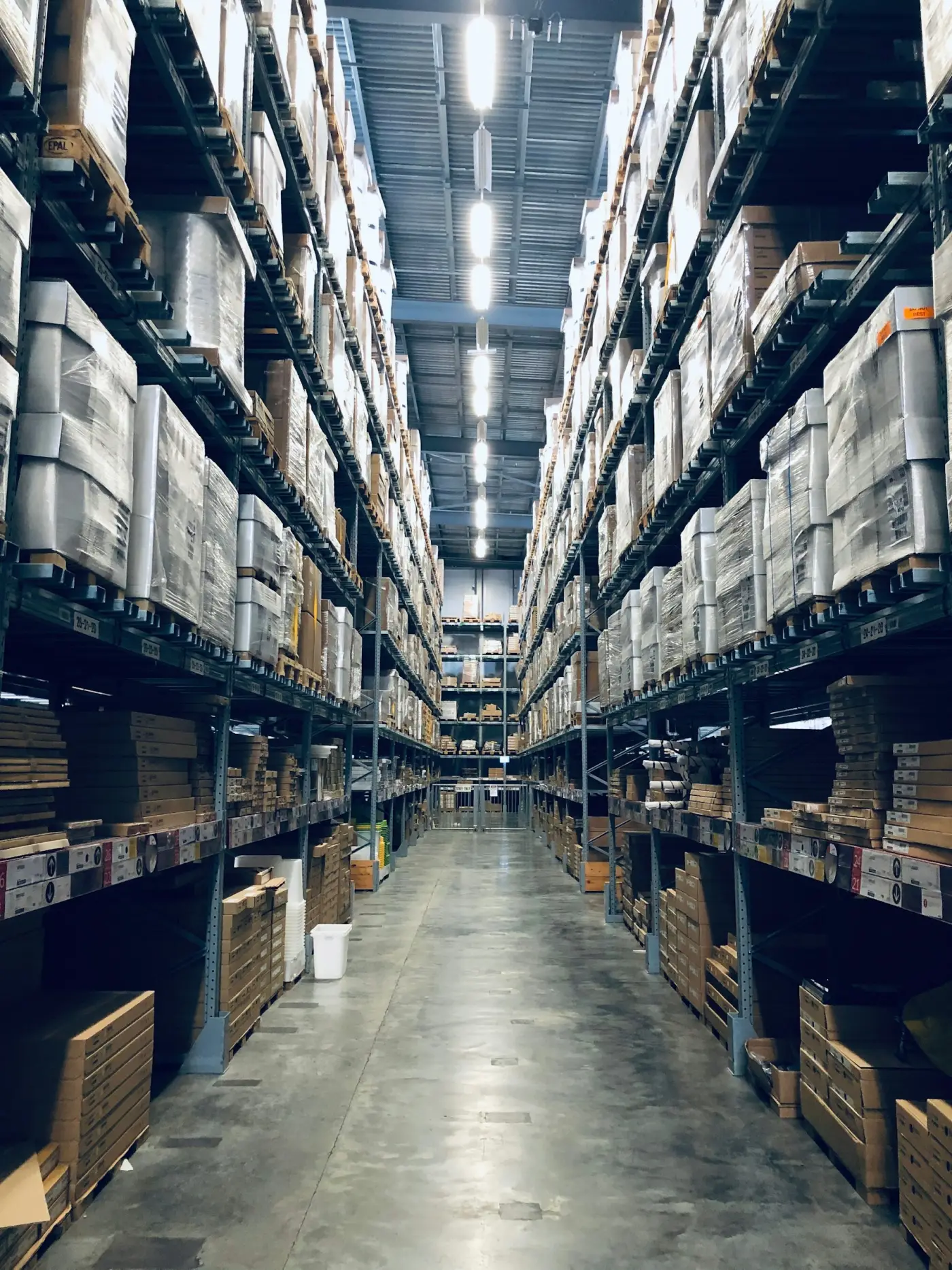A long warehouse aisle lined with pallet racking